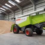 Farming machinery inside a large steel framed building