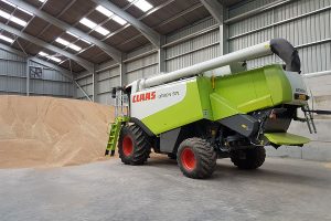 Farming machinery inside a large steel framed building